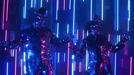 Funny-dancers-in-sparkling-costumes-dancing-in-sync-against-a-neon-wall.